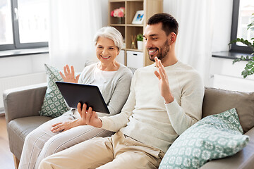 Image showing old mother and adult son with tablet pc at home