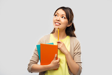 Image showing asian student woman with books and pencil