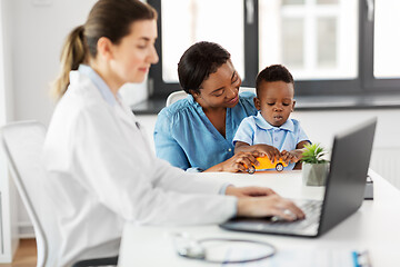 Image showing happy mother with baby son and doctor at clinic