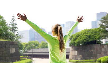 Image showing happy woman in sports clothes at tokyo city park