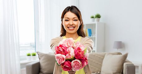 Image showing happy asian woman with bunch of flowers at home