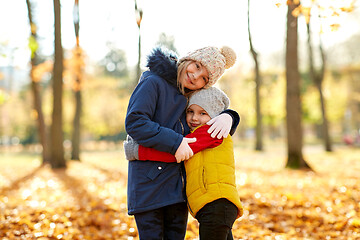 Image showing happy children hugging at autumn park