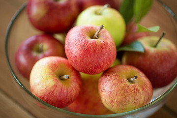 Image showing ripe apples in glass bowl on wooden table