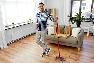 Image showing man with broom cleaning floor at home