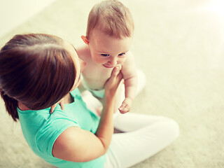 Image showing happy young mother with little baby at home