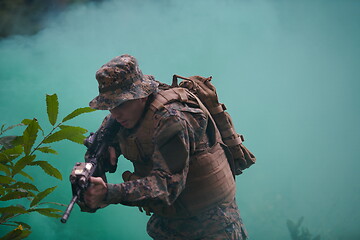 Image showing soldier in action aiming  on weapon  laser sight optics