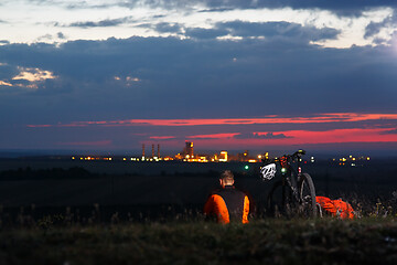 Image showing guy has a rest sitting near his bike