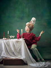 Image showing Young woman as Marie Antoinette on dark background. Retro style, comparison of eras concept.