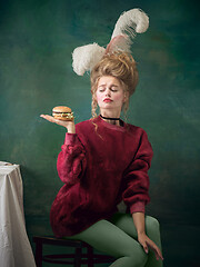 Image showing Young woman as Marie Antoinette on dark background. Retro style, comparison of eras concept.