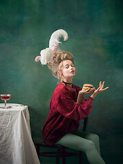 Image showing Young woman as Marie Antoinette on dark background. Retro style, comparison of eras concept.