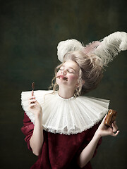 Image showing Young woman as Marie Antoinette on dark background. Retro style, comparison of eras concept.