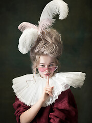 Image showing Young woman as Marie Antoinette on dark background. Retro style, comparison of eras concept.