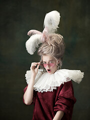 Image showing Young woman as Marie Antoinette on dark background. Retro style, comparison of eras concept.