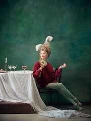 Image showing Young woman as Marie Antoinette on dark background. Retro style, comparison of eras concept.