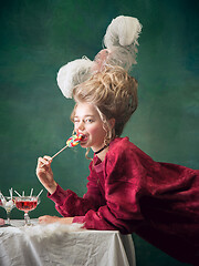 Image showing Young woman as Marie Antoinette on dark background. Retro style, comparison of eras concept.