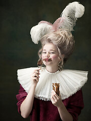 Image showing Young woman as Marie Antoinette on dark background. Retro style, comparison of eras concept.