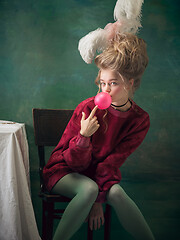 Image showing Young woman as Marie Antoinette on dark background. Retro style, comparison of eras concept.