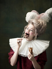 Image showing Young woman as Marie Antoinette on dark background. Retro style, comparison of eras concept.