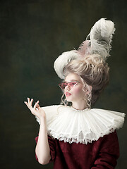 Image showing Young woman as Marie Antoinette on dark background. Retro style, comparison of eras concept.