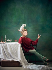 Image showing Young woman as Marie Antoinette on dark background. Retro style, comparison of eras concept.