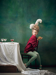 Image showing Young woman as Marie Antoinette on dark background. Retro style, comparison of eras concept.