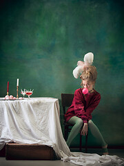 Image showing Young woman as Marie Antoinette on dark background. Retro style, comparison of eras concept.