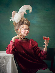 Image showing Young woman as Marie Antoinette on dark background. Retro style, comparison of eras concept.