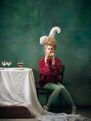 Image showing Young woman as Marie Antoinette on dark background. Retro style, comparison of eras concept.