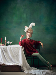 Image showing Young woman as Marie Antoinette on dark background. Retro style, comparison of eras concept.