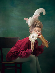 Image showing Young woman as Marie Antoinette on dark background. Retro style, comparison of eras concept.