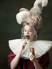 Image showing Young woman as Marie Antoinette on dark background. Retro style, comparison of eras concept.