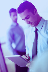 Image showing business man using tablet compuer at office