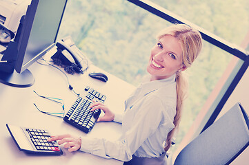 Image showing business woman working on her desk in an office