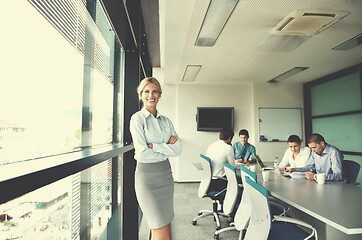 Image showing business woman with her staff in background at office