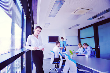 Image showing business woman with her staff in background at office