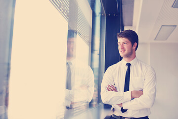 Image showing business man  on a meeting in offce with colleagues in backgroun