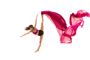 Image showing Ballerina. Young graceful female ballet dancer dancing over white studio. Beauty of classic ballet.