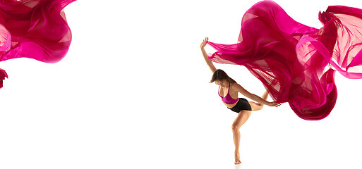 Image showing Ballerina. Young graceful female ballet dancer dancing over white studio. Beauty of classic ballet.