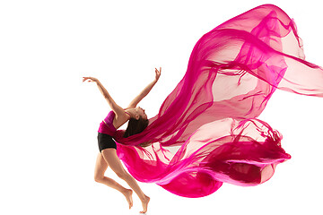 Image showing Ballerina. Young graceful female ballet dancer dancing over white studio. Beauty of classic ballet.