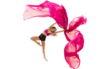 Image showing Ballerina. Young graceful female ballet dancer dancing over white studio. Beauty of classic ballet.