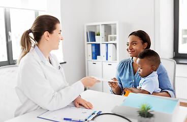 Image showing happy mother with baby son and doctor at clinic