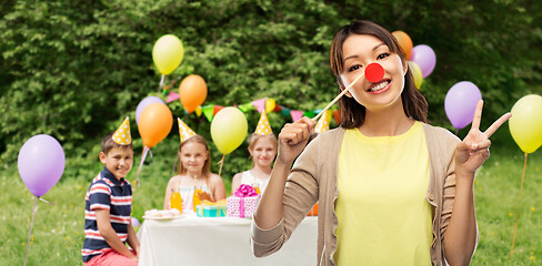 Image showing woman with clown nose at children\'s birthday party