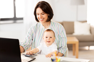 Image showing working mother with baby boy and laptop at home