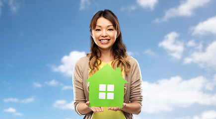 Image showing happy asian woman with green house