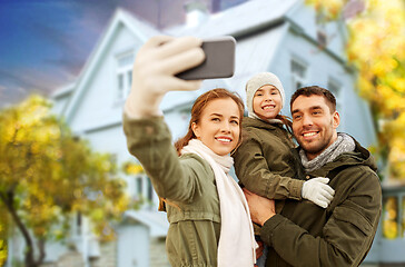 Image showing family taking selfie over house in autumn