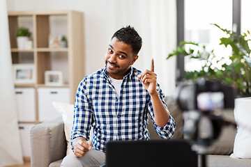 Image showing male blogger with camera videoblogging at home