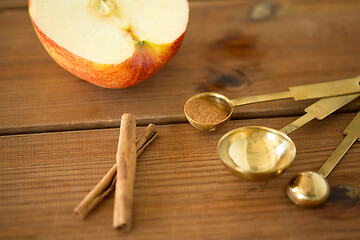 Image showing half apple and knife on wooden cutting board