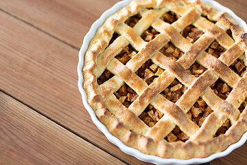 Image showing close up of apple pie in mold on wooden table