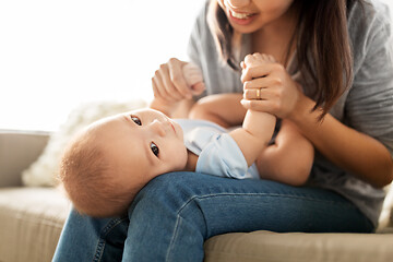 Image showing happy young mother with little baby son at home