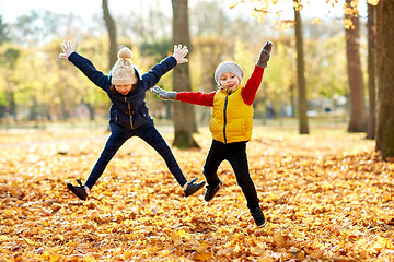 Image showing happy children running at autumn park